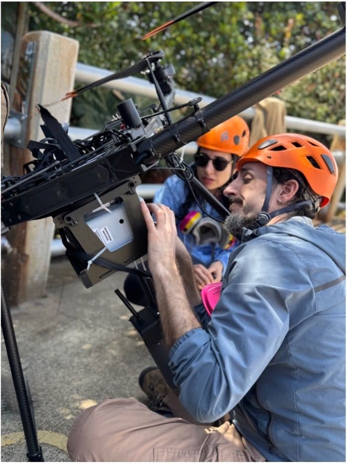 Girona (foreground) and Drymoni (background) inspect the drone pre-flight.
