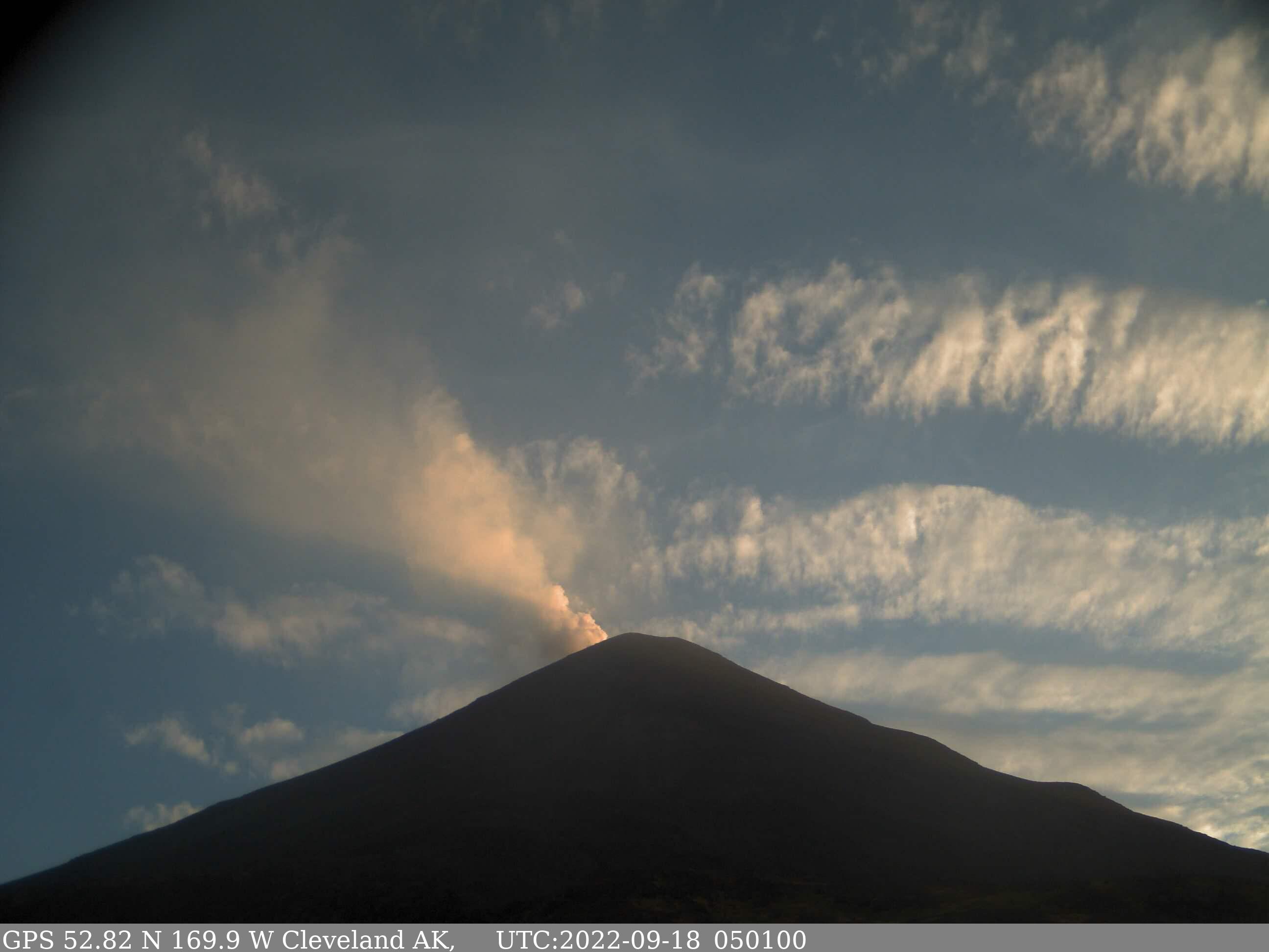 An example view of the summit of Cleveland from the CLNE site. The silhouette of Cleveland is present in the foreground, with the plume visible against a blue sky.