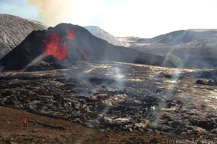 The eruption of Fagradalsfjall, Iceland, showing the main cone early in the course of the eruption, with fresh lava fountaining inside the cone and lava flows in the foreground.